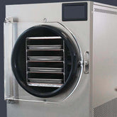 A large and empty metallic industrial freeze-drying machine