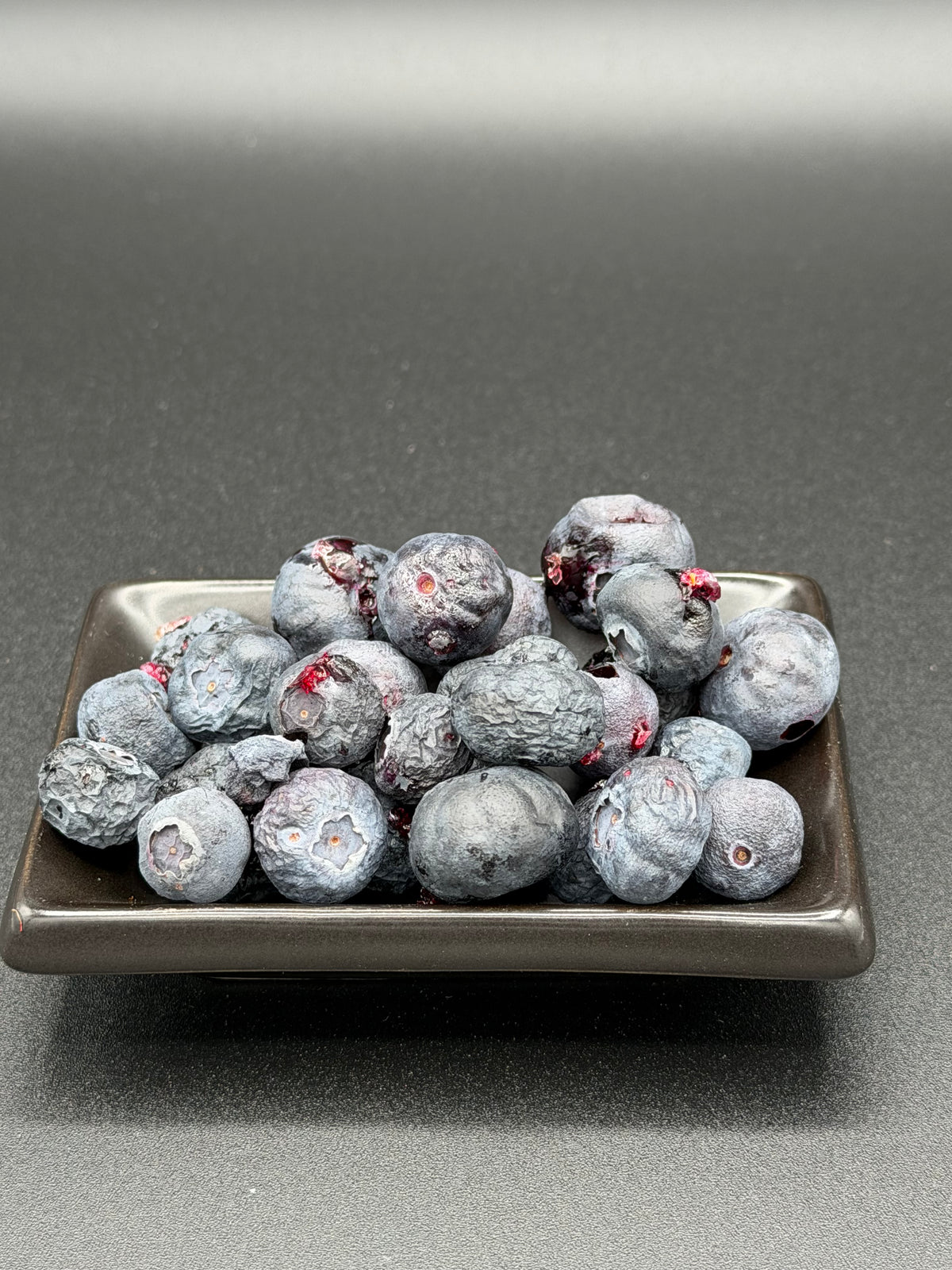 Freeze-dried blueberries poured from an Outback Bites pouch