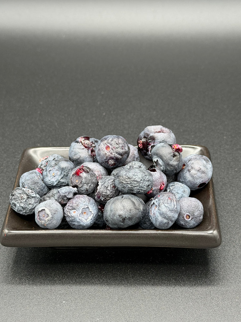 Freeze-dried blueberries poured from an Outback Bites pouch