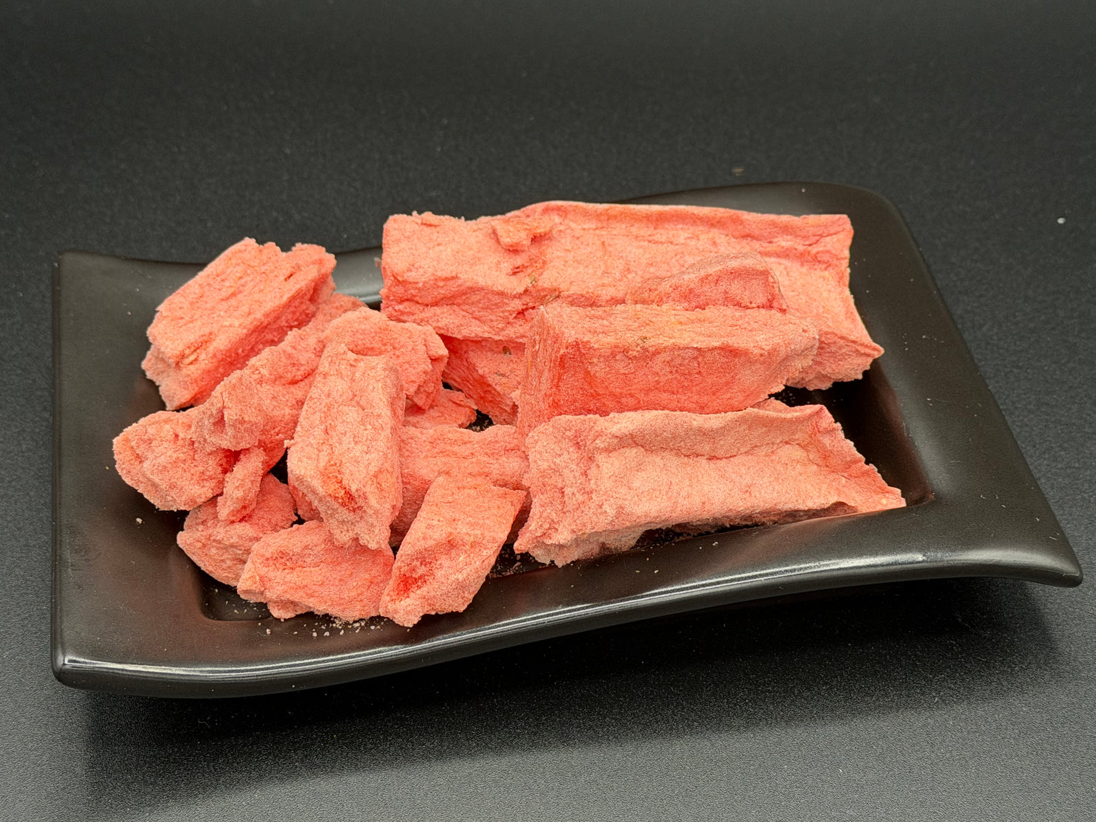 Freeze-dried watermelon pieces on a plate